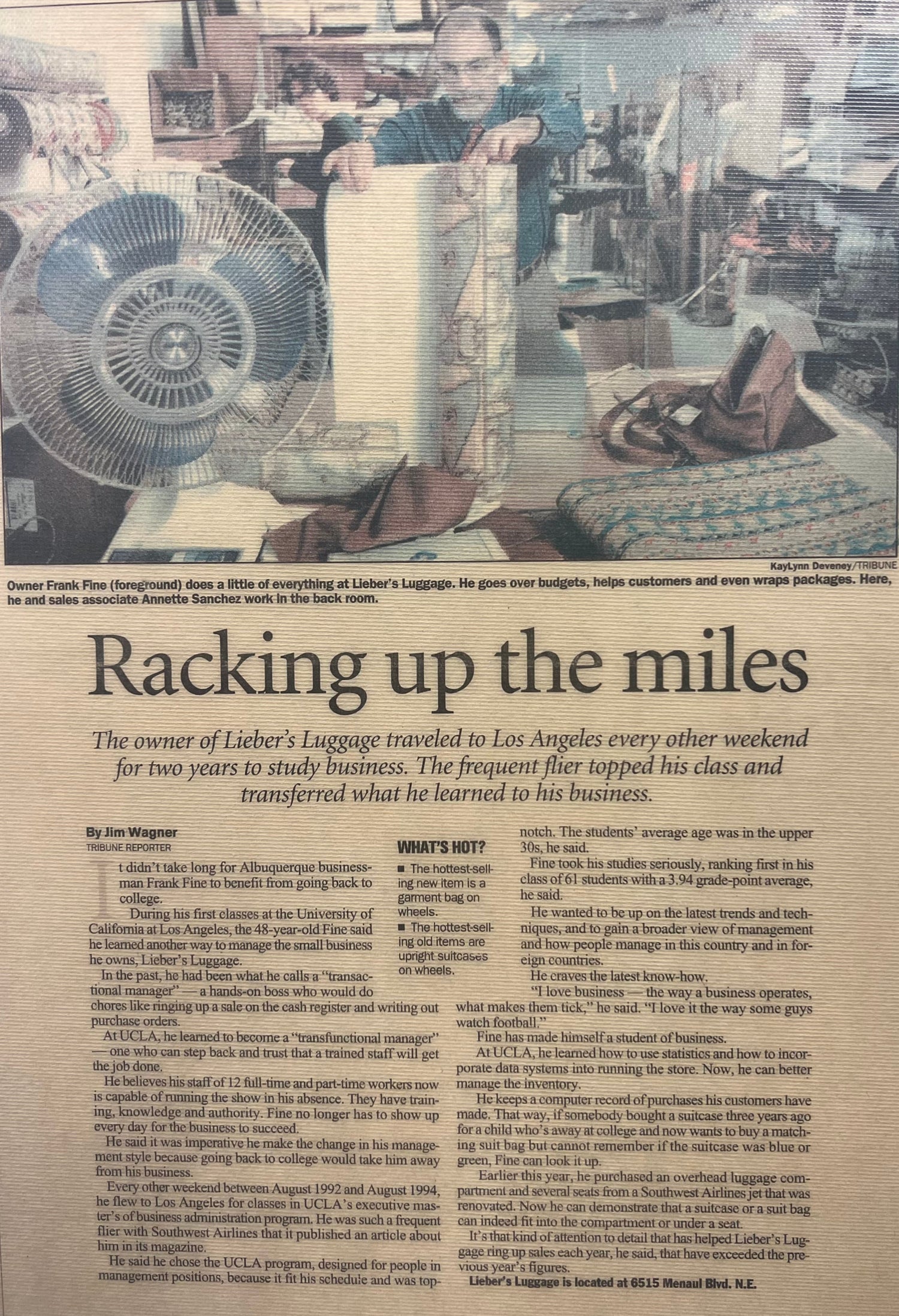 Newspaper article with a man working near a large fan in a warehouse setting.
