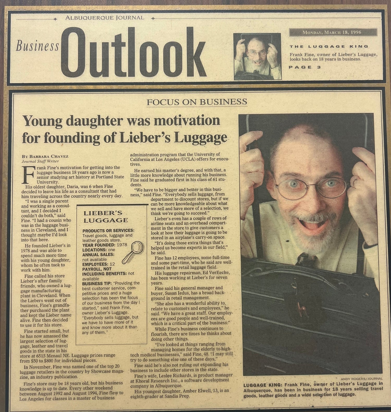 Framed newspaper clipping with a portrait and text on a wooden frame.