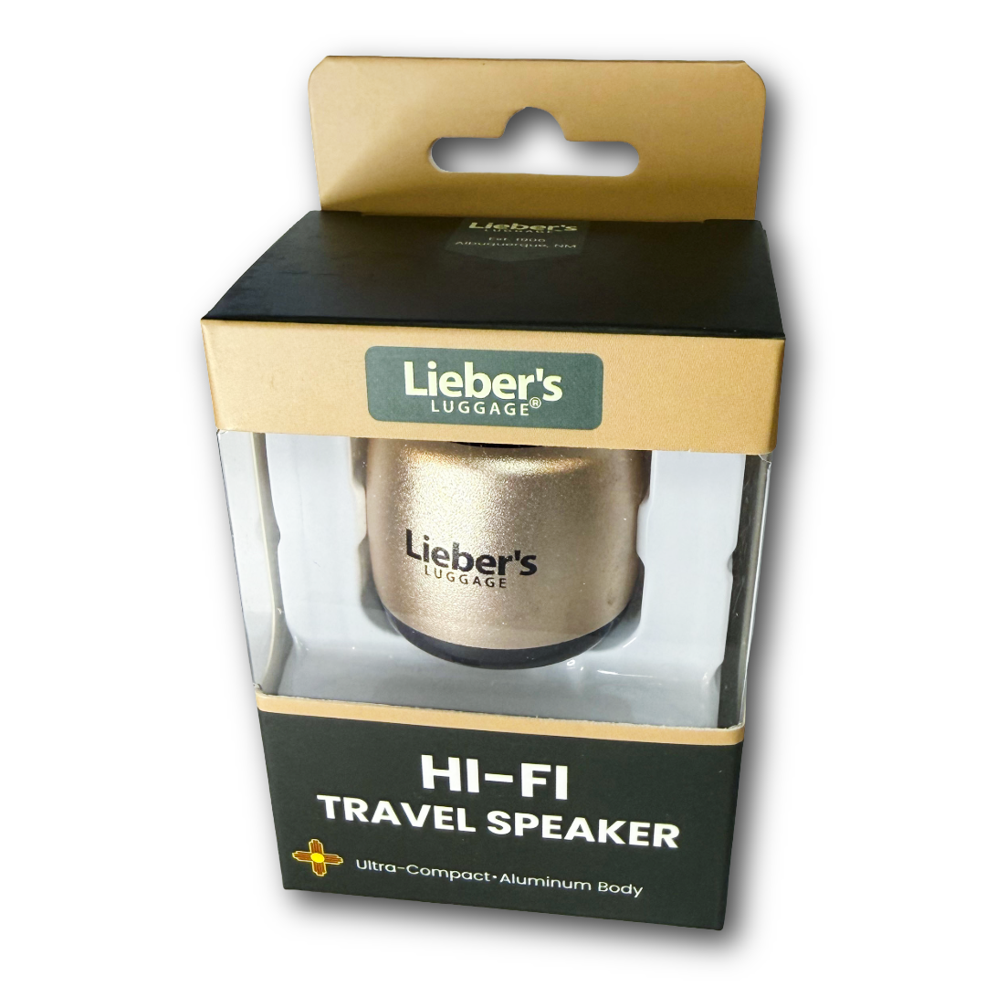 Lieber's Luggage Hi-Fi Travel Speaker in its original retail packaging, featuring a gold aluminum speaker inside a clear plastic window box with a black and gold cardboard sleeve.
